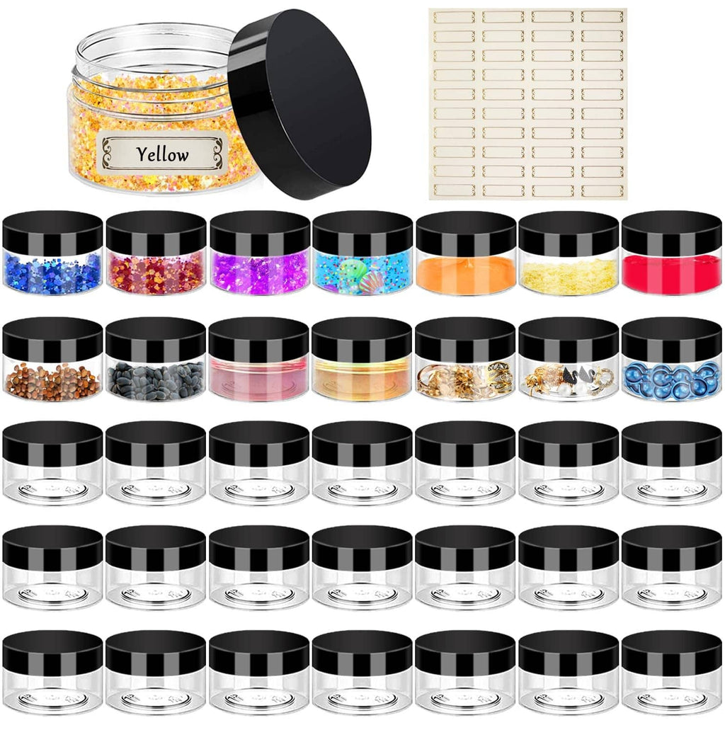 Set of small clear jars with black lids filled with multicolor craft glitter