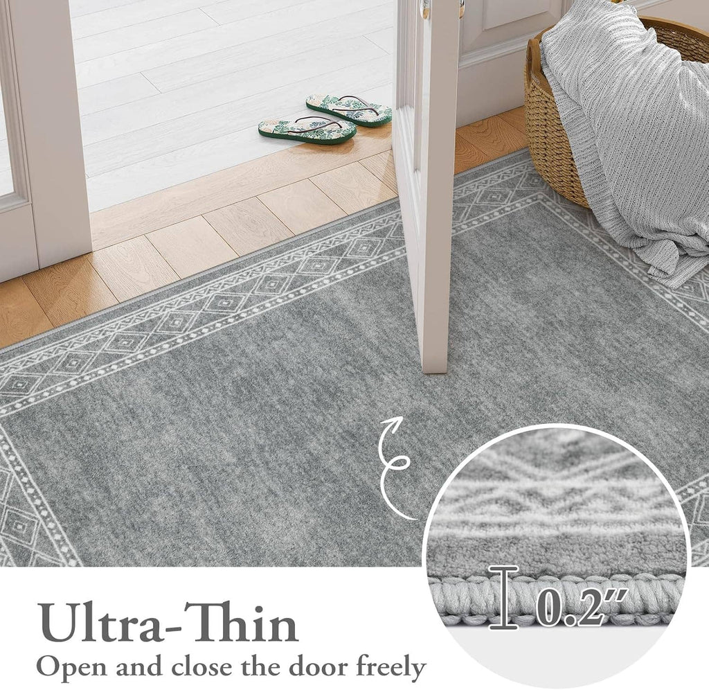 Low-profile gray runner rug with geometric border pattern, placed at a doorway