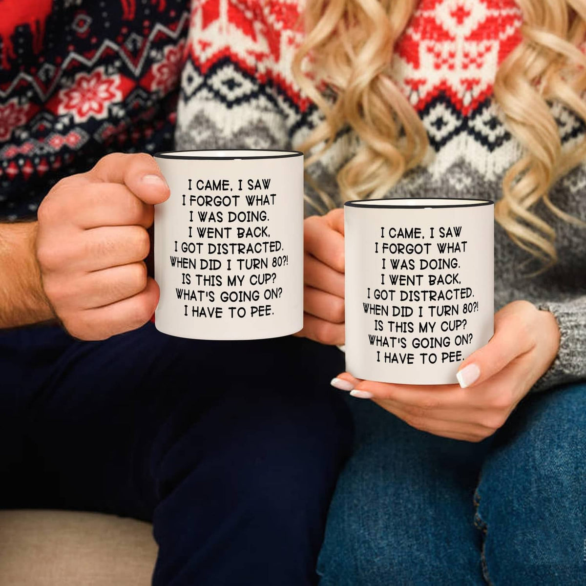 Two white mugs with black handles and rims, birthday joke text about turning 80.