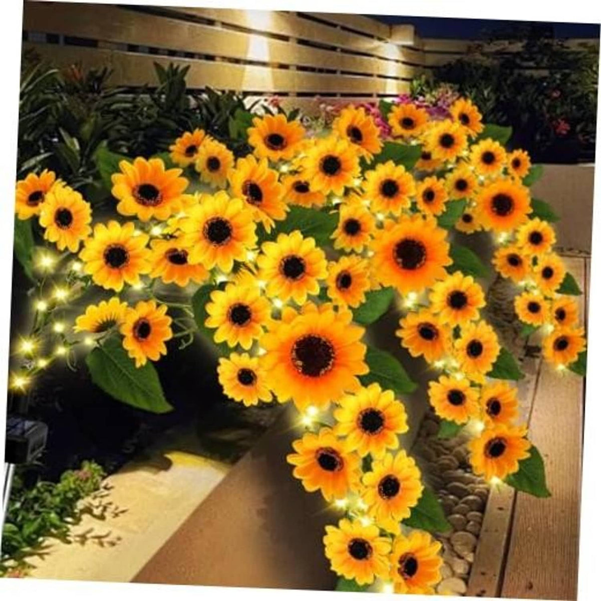 Solar sunflower garden lights with warm white glowing LEDs and green leaves
