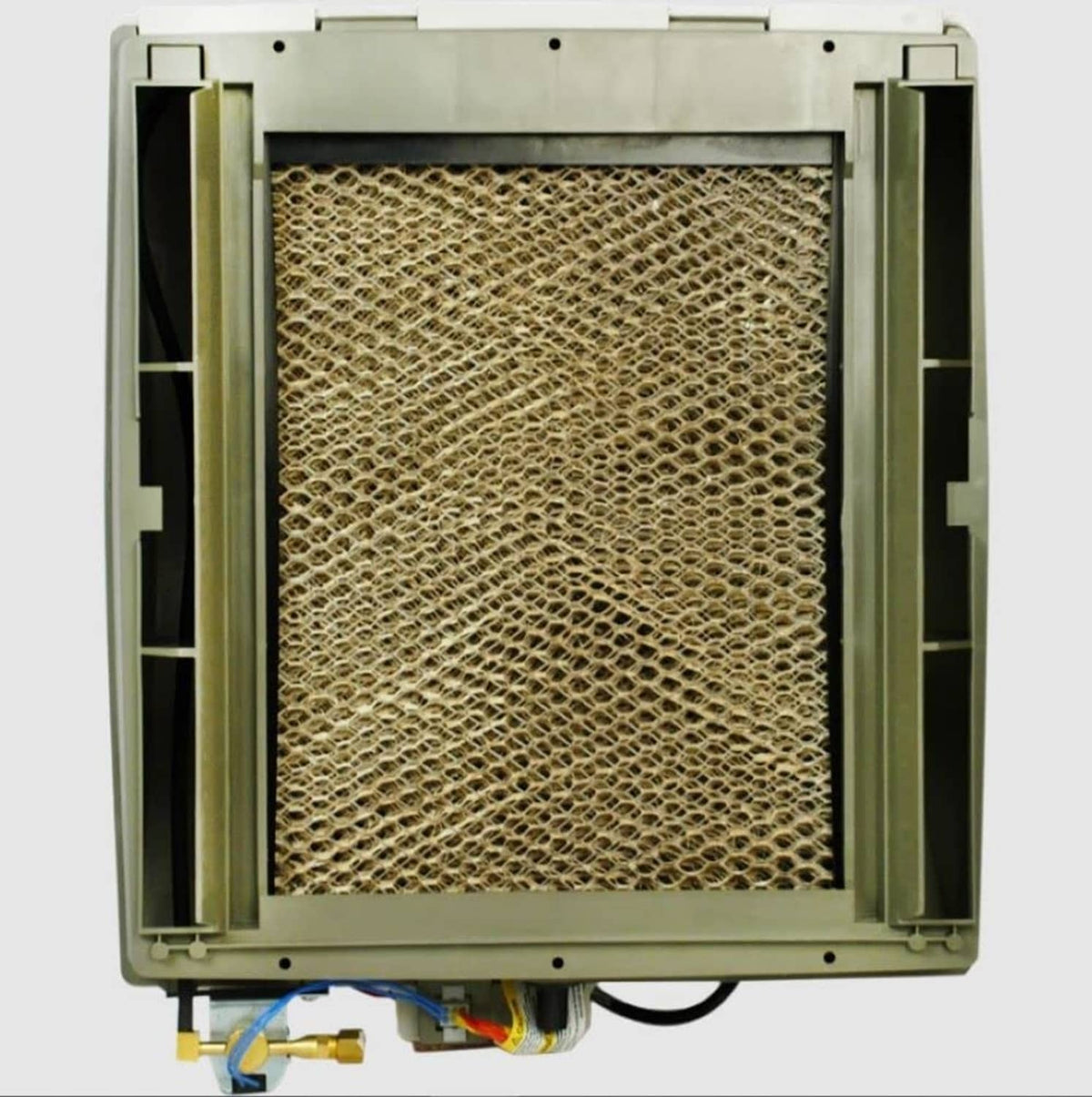 Whole-home humidifier open housing showing textured evaporator pad inside frame