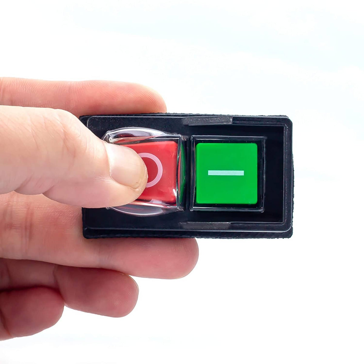 Magnetic on/off switch with red O and green I rocker buttons, finger pressing