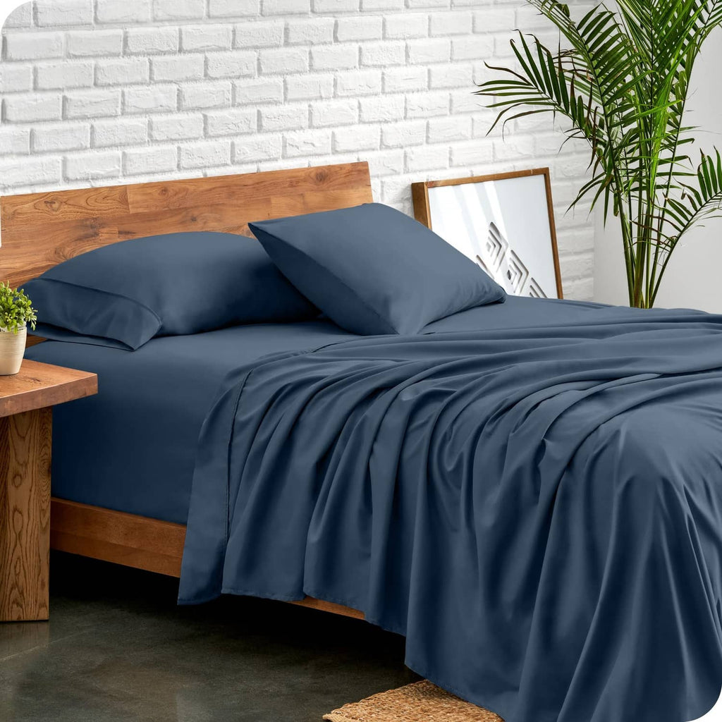 Blue twin bed linen set with draped flat sheet and two coordinating pillowcases
