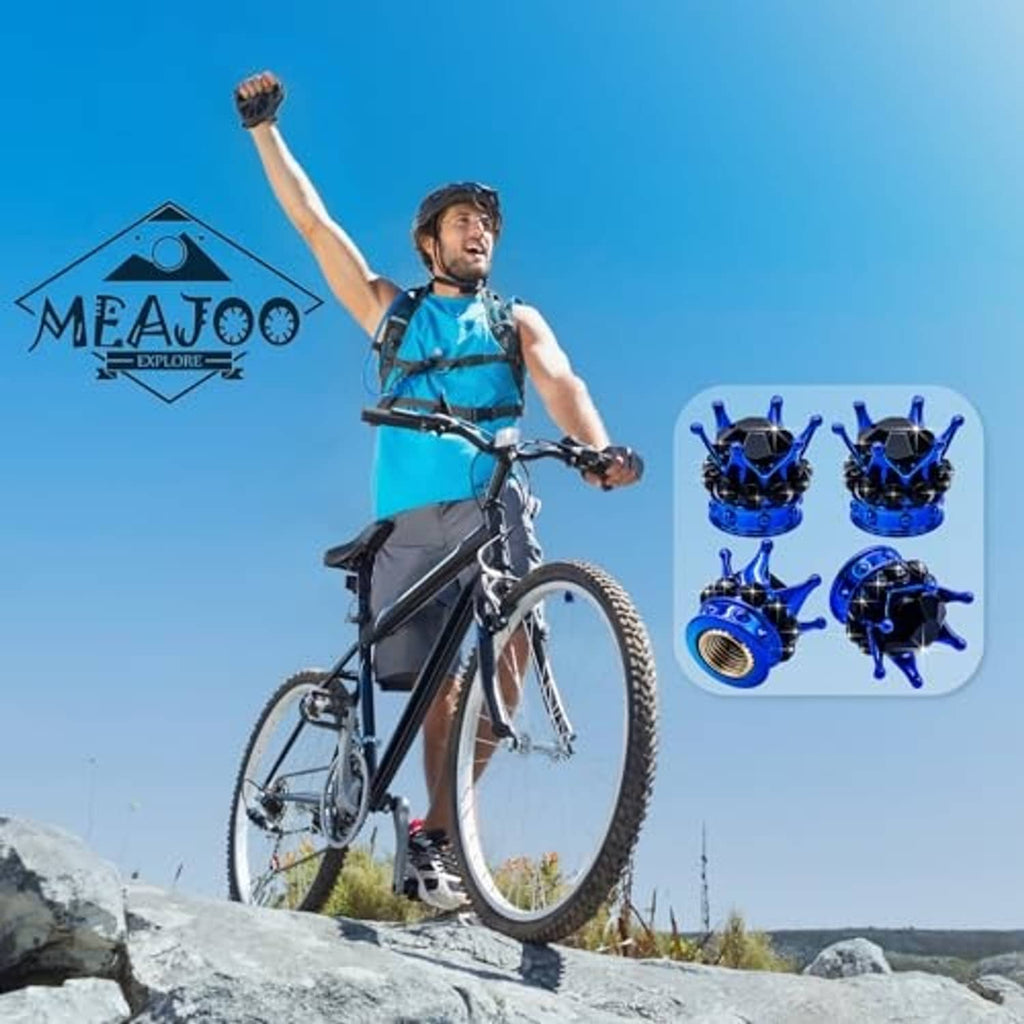 Four blue crown tire valve stem caps with black faceted crystals, shown with bike