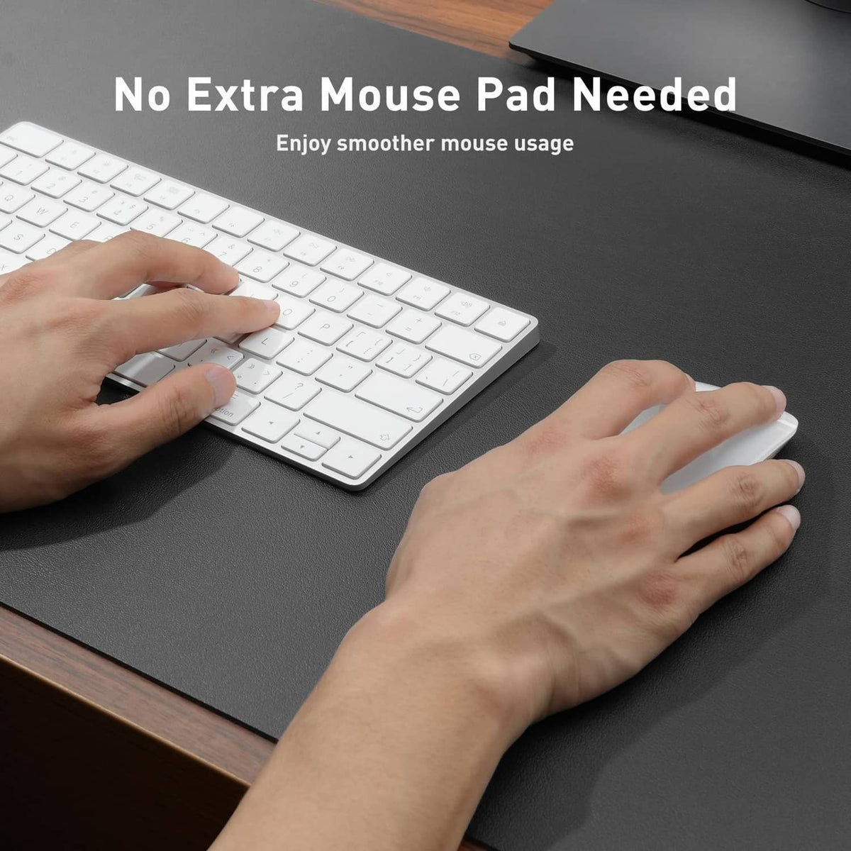 Gray desk pad protector with smooth surface under hands using keyboard and mouse