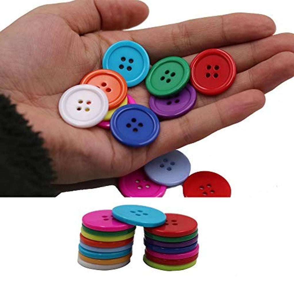 Round four-hole resin sewing buttons in mixed colors resting on open palm, flatback style