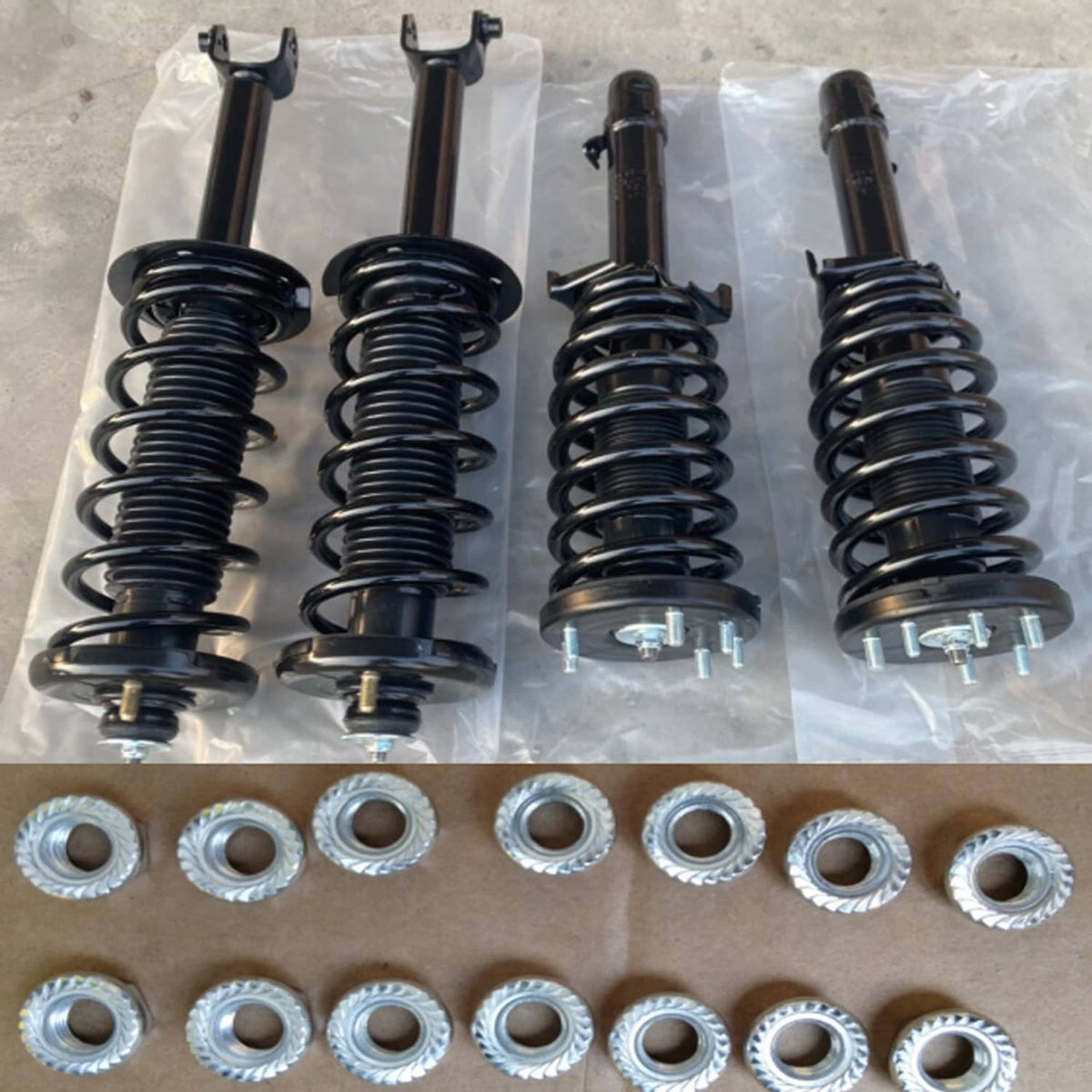 4-piece complete shock strut set with black coil springs and mounting hardware