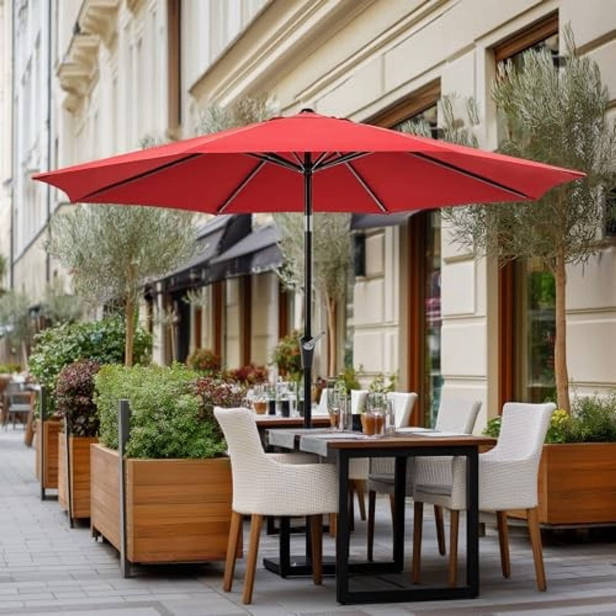 Dark red outdoor patio umbrella shading a dining table with chairs