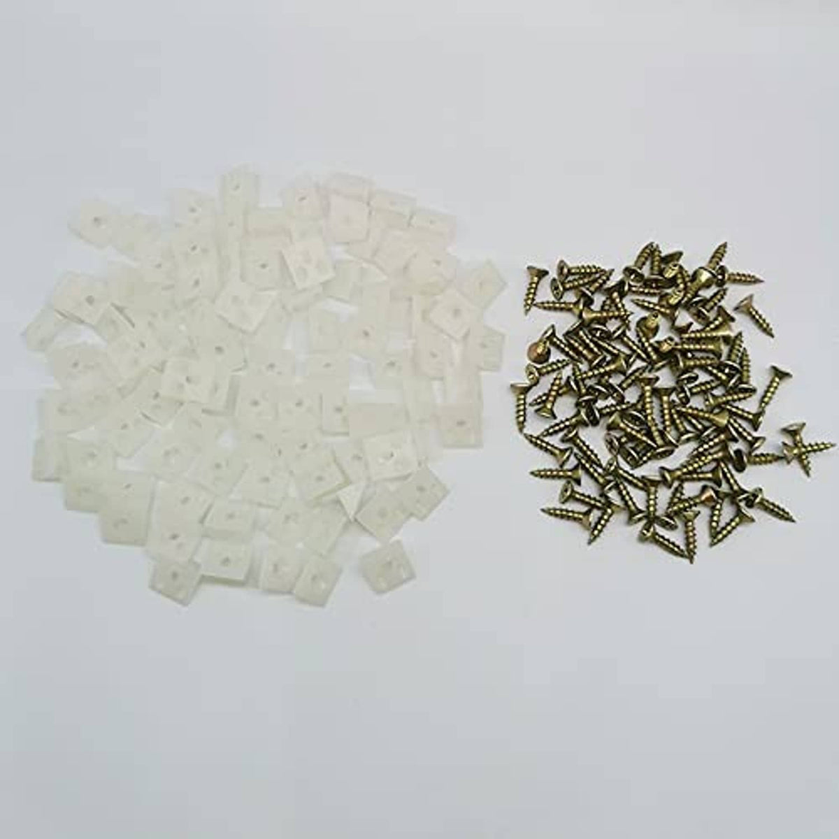 White wedge anchors and small gold screws for furniture drawer repairs
