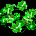 Green shamrock string lights with glowing LED clover shapes on a thin wire strand