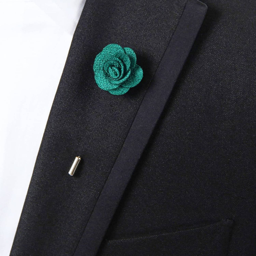 Teal fabric rose lapel pin on dark suit lapel, close-up