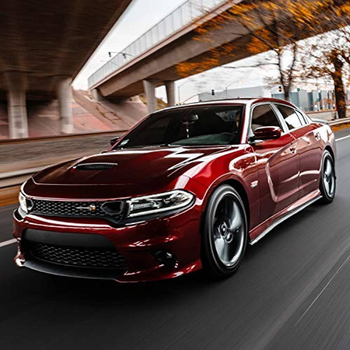 Red car with black universal side skirt trim along the rocker panel
