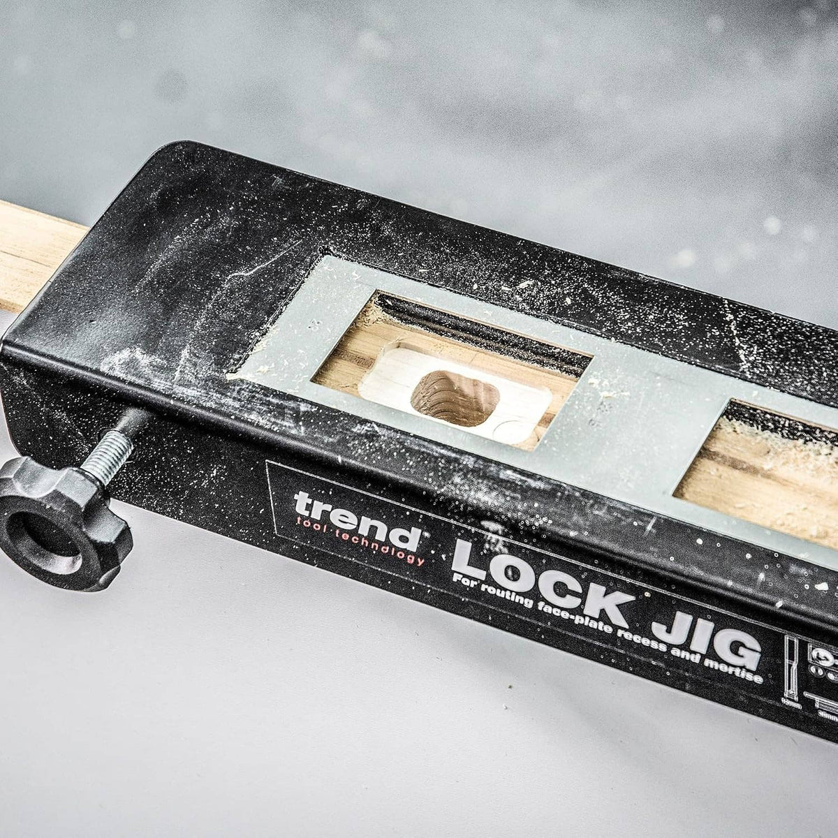 Trend lock jig with metal plate and mounting holes, branded close-up on a work surface