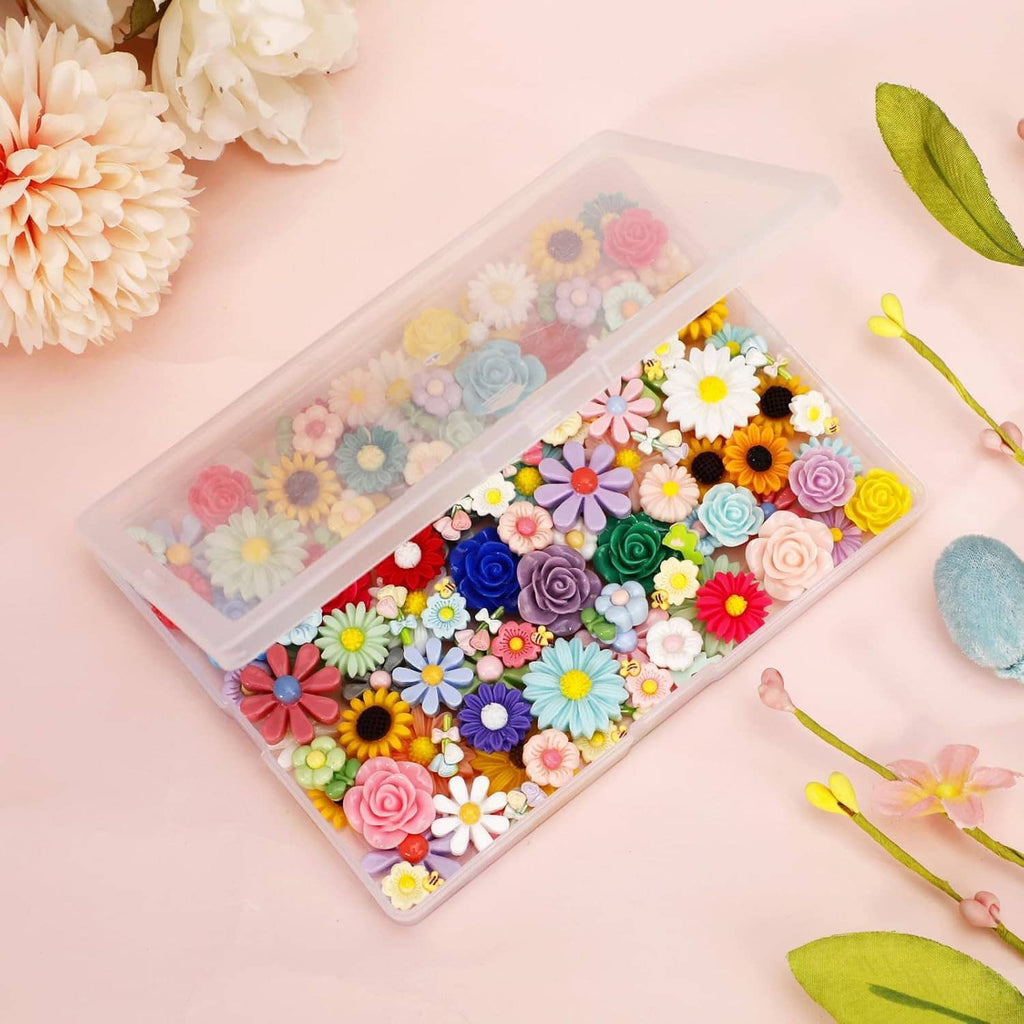 Assorted mini flatback resin flowers in a clear organizer box