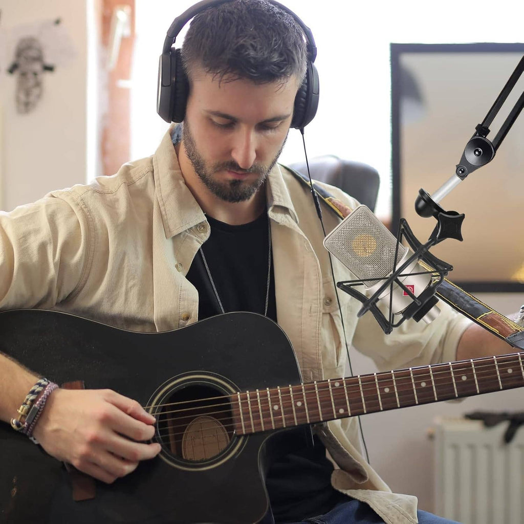 Condenser microphone in black shock mount on studio boom arm