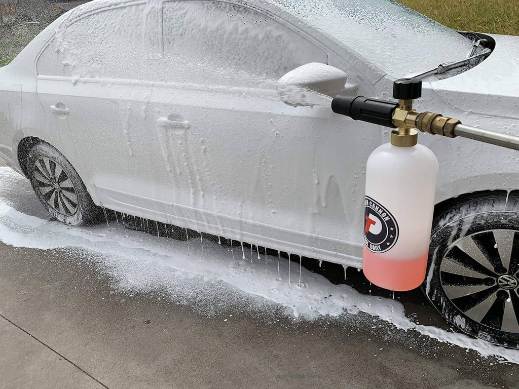 Foam cannon applying soap foam to a car body with brass adjustable nozzle and bottle