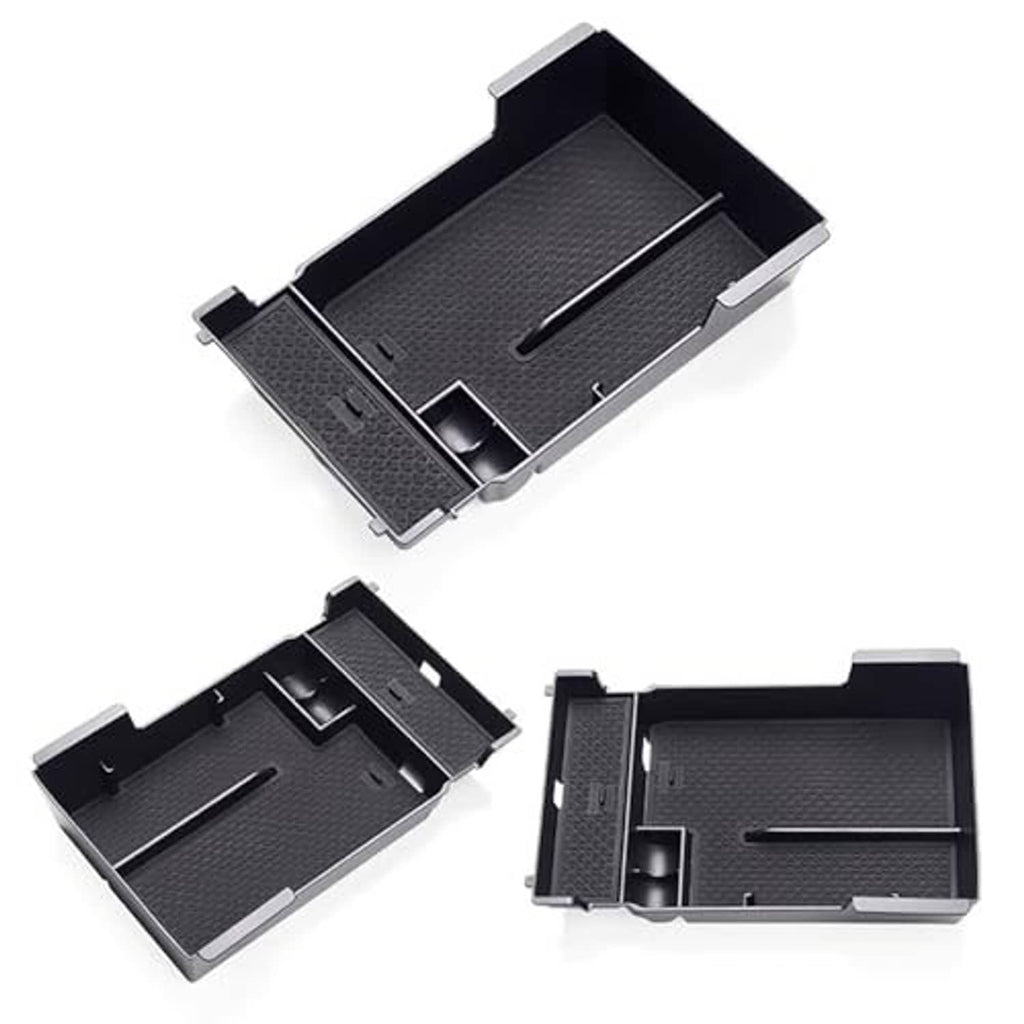 Set of black armrest cover components with textured surfaces and raised edges