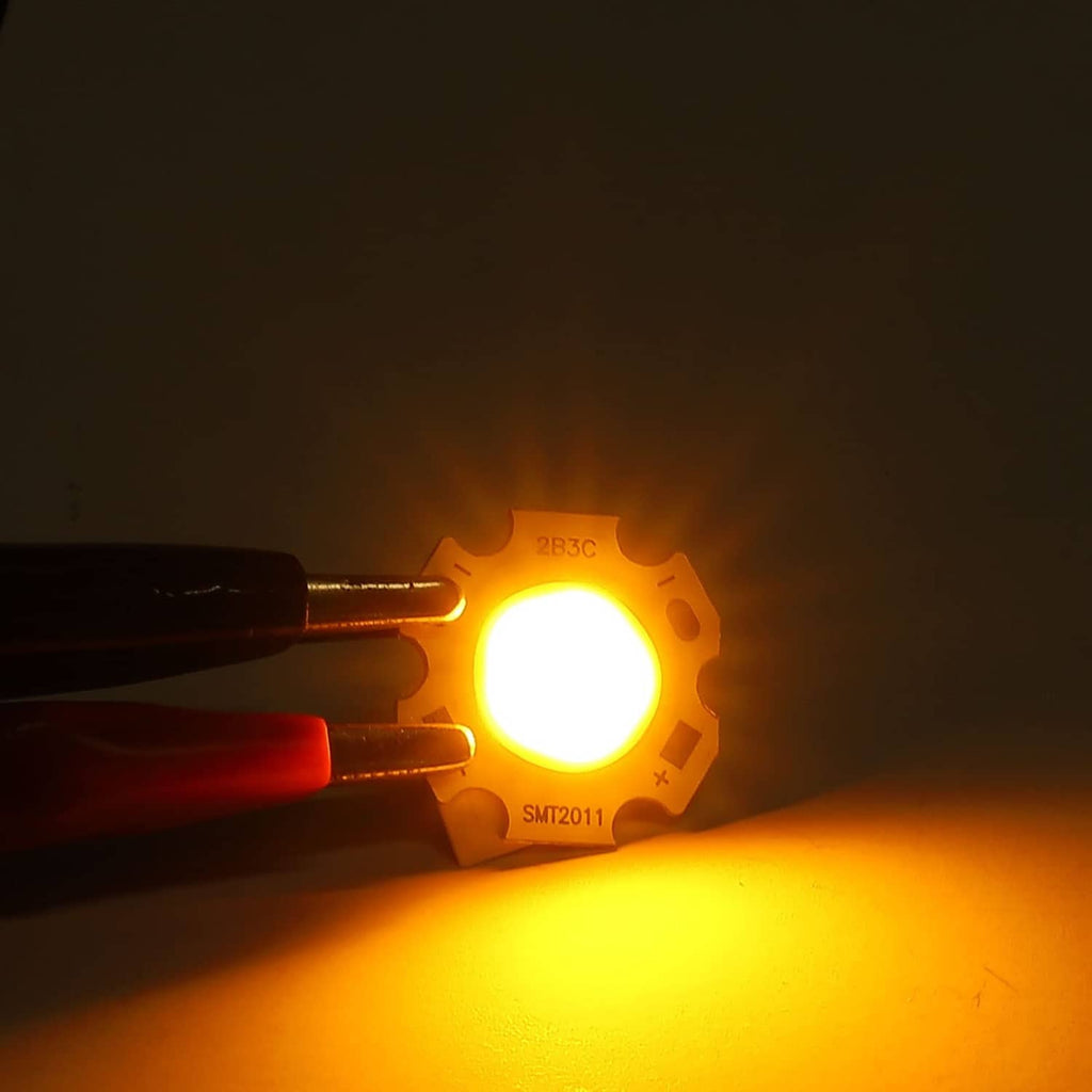 Warm white LED COB chip glowing, bright yellow light from central lens