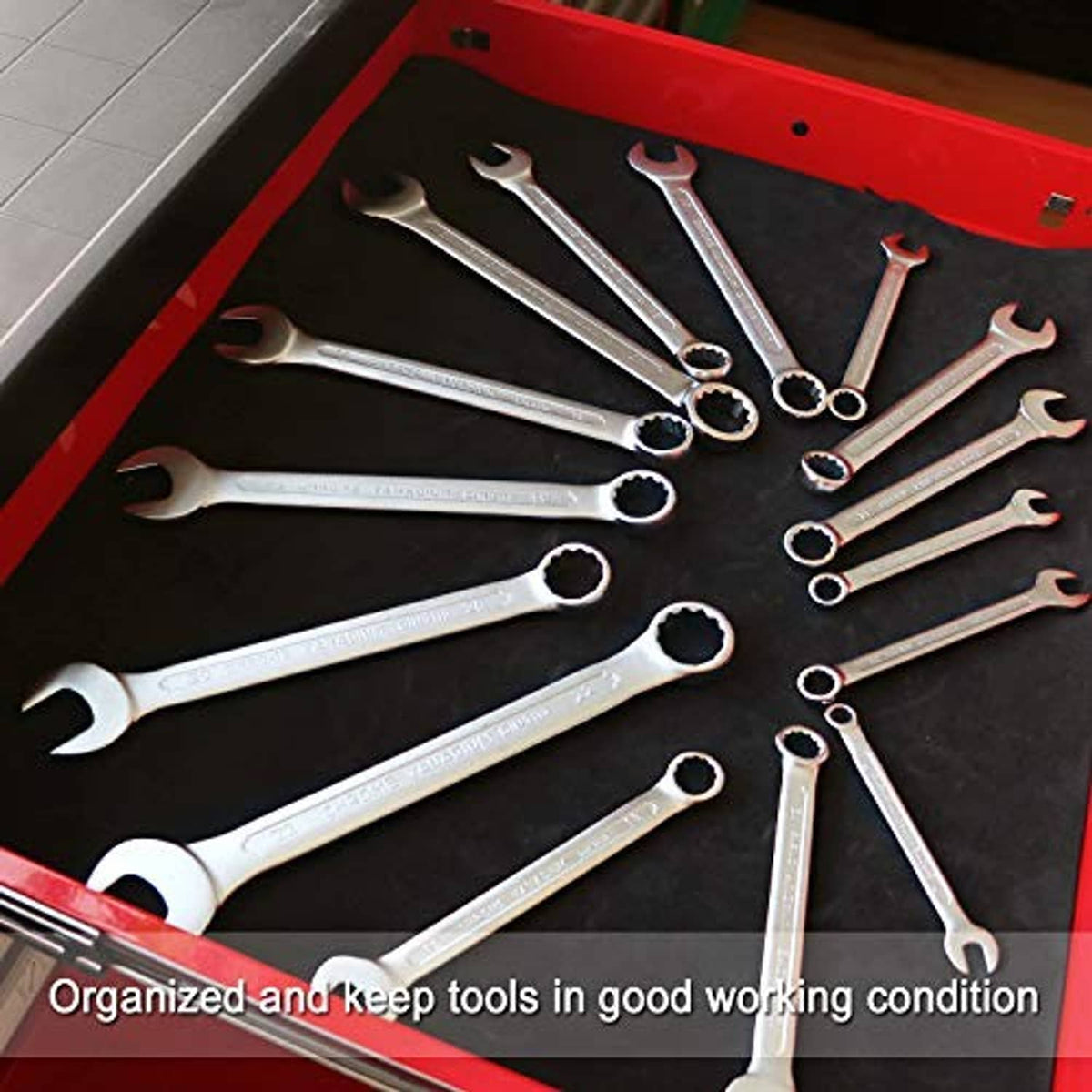 Black tool box liner with neatly arranged wrenches in an open tool drawer