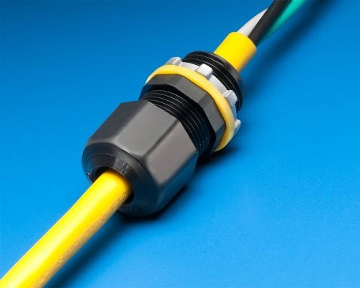 Gray connector with black cap, yellow strain-relief band, and threaded cable end