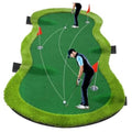 Golf putting green mat with three practice holes and red flags on green artificial turf