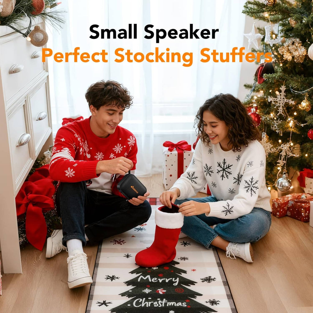 Portable Bluetooth speaker in Christmas setting, black speaker with orange handle