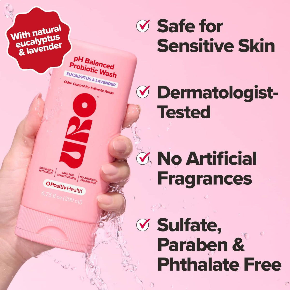Probiotic wash bottle held in hand, pink front label, water splash, safe for sensitive skin
