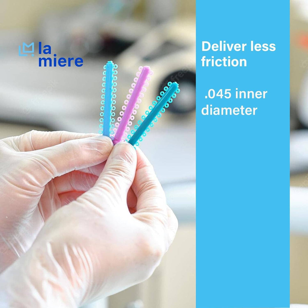 Orthodontic elastic ligature ties held in hand with blue and teal stick loops