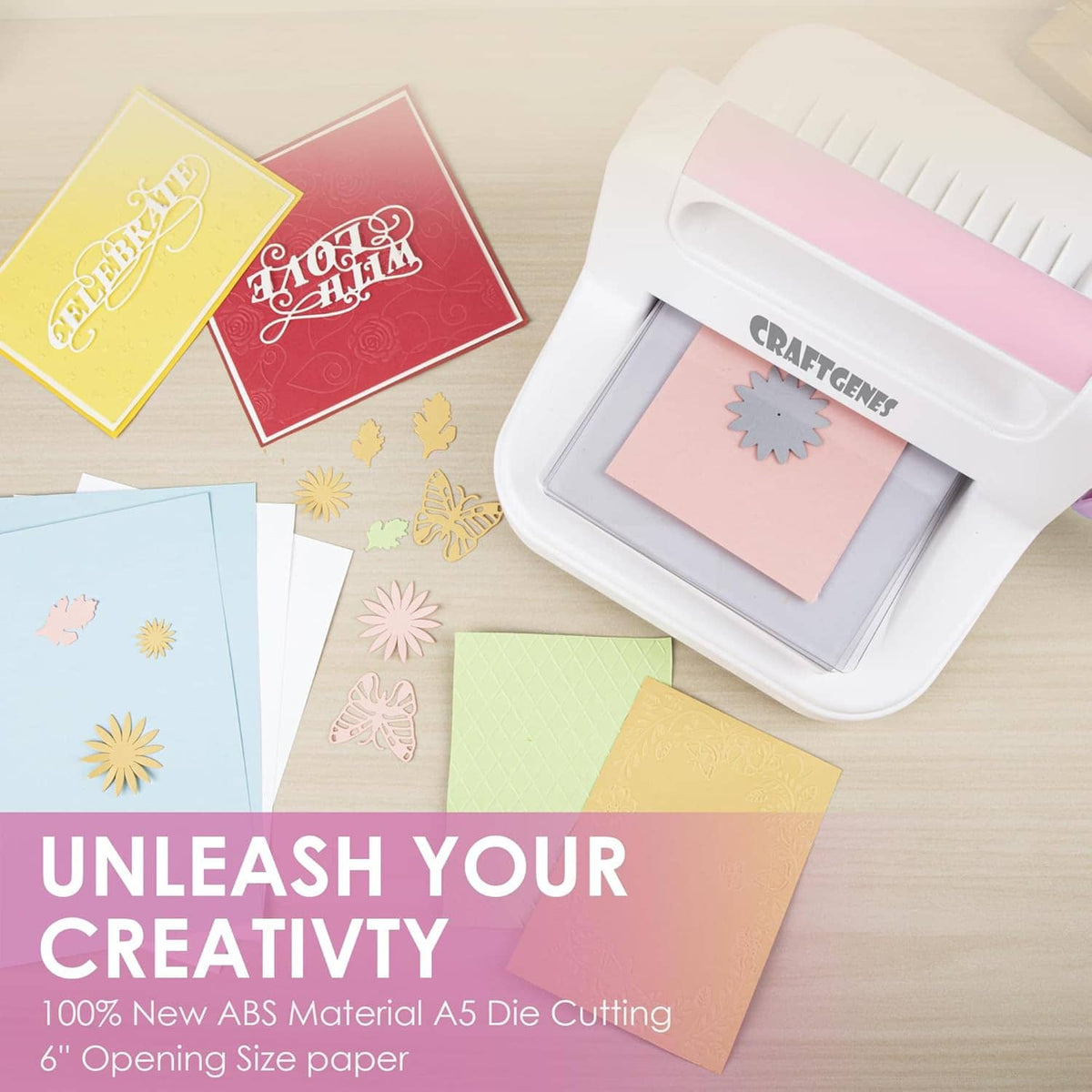Die cutting and embossing machine with folder and colored paper pieces, white and pink, CRAFTGENES