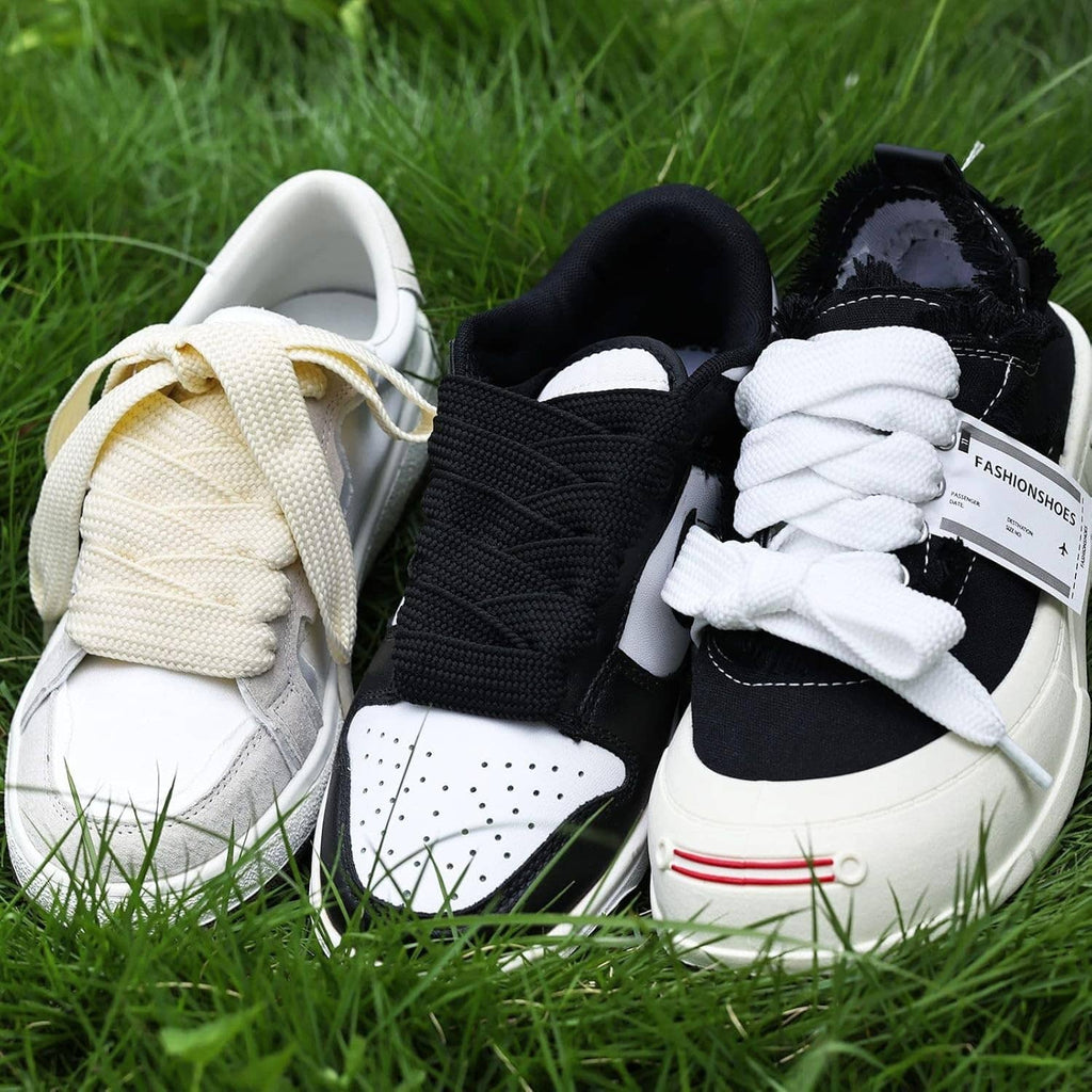 Thick 3/4-inch sneaker laces in cream, black, and white on shoes