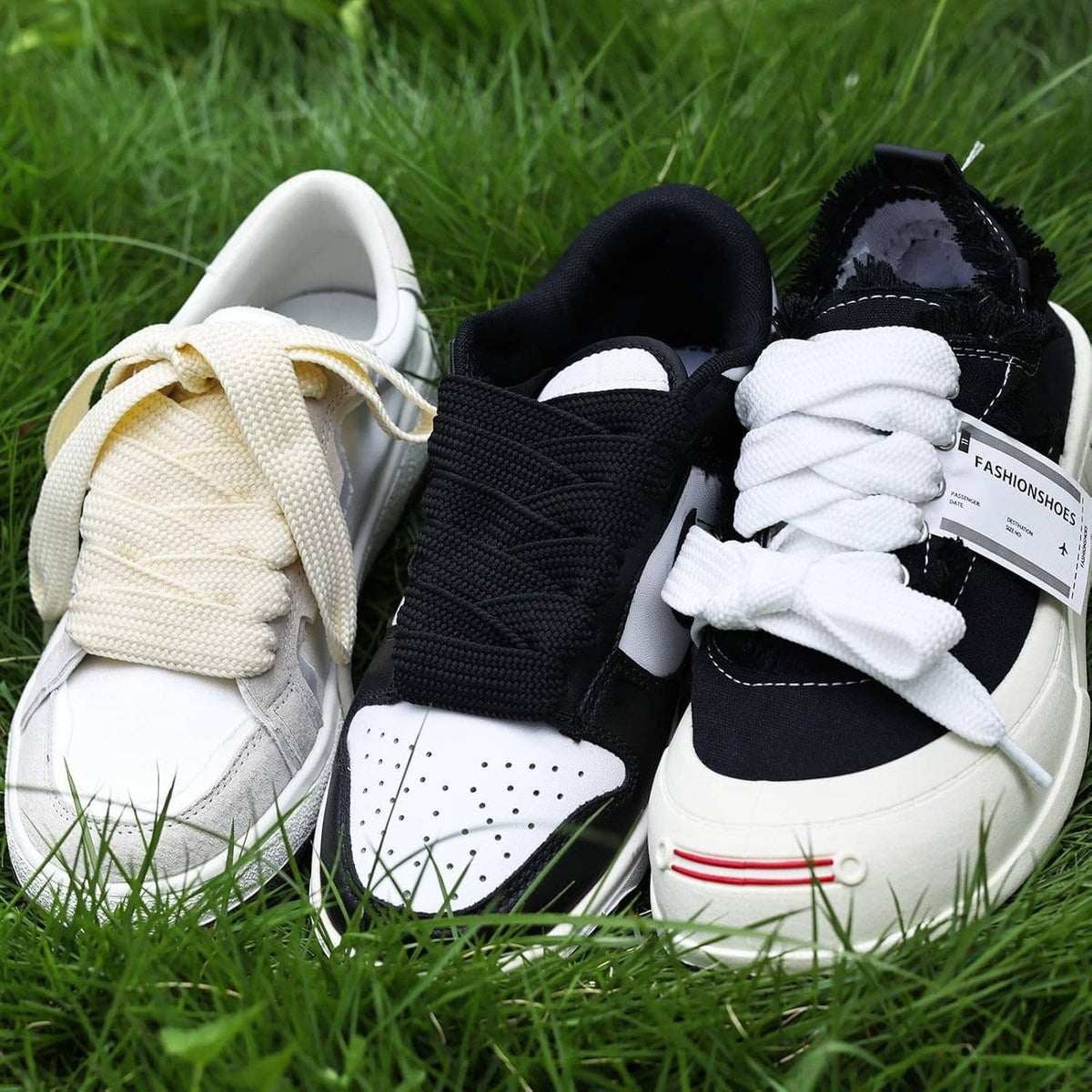 Thick 3/4-inch sneaker laces in cream, black, and white on shoes