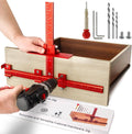 Cabinet handle jig with red aluminum guide on wood drawer, drill bit installation setup