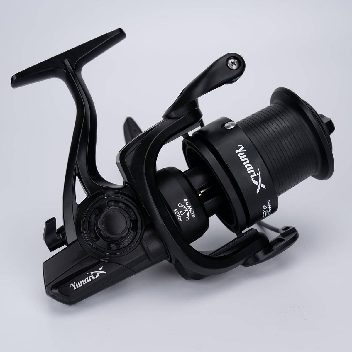 Black spinning fishing reel 3/4 view with large ribbed spool and bail arm