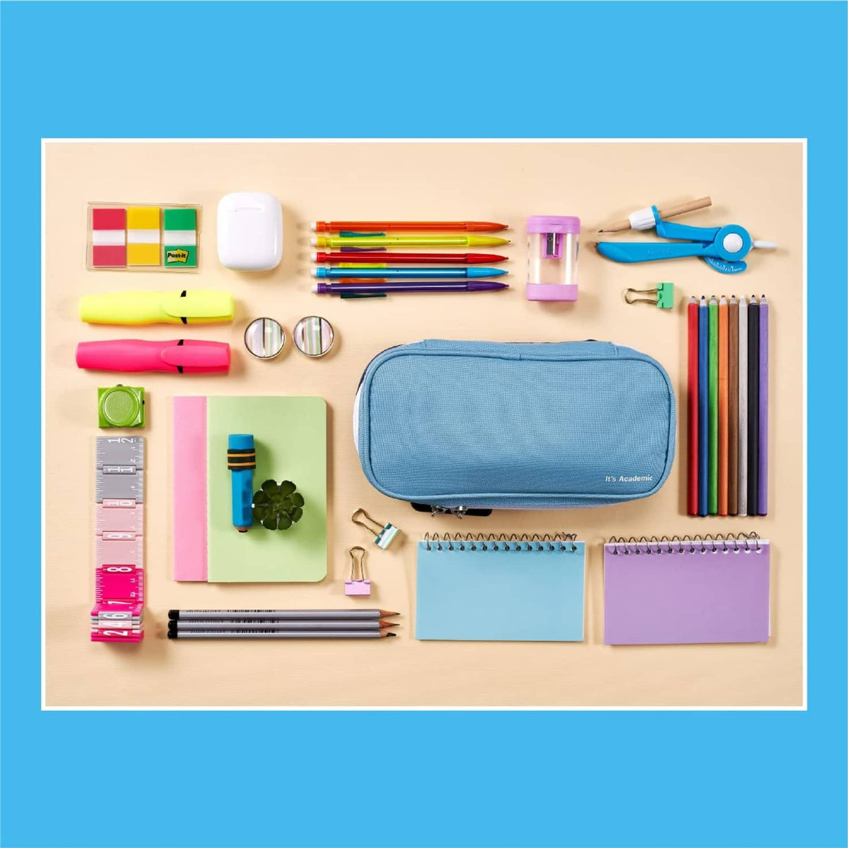 Blue locking pencil case lying flat on desk with stationery supplies around it.