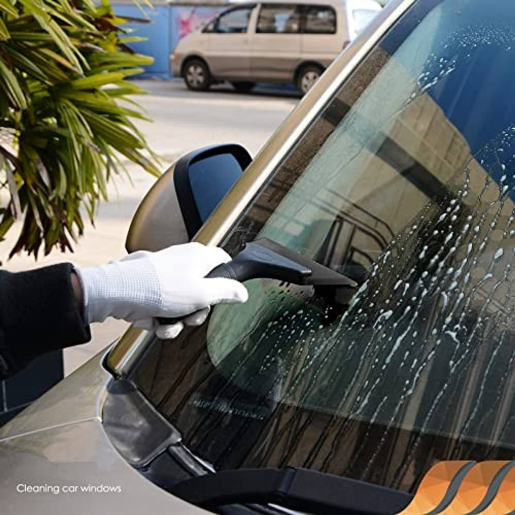 Black rubber squeegee cleaning a car window with a gloved hand