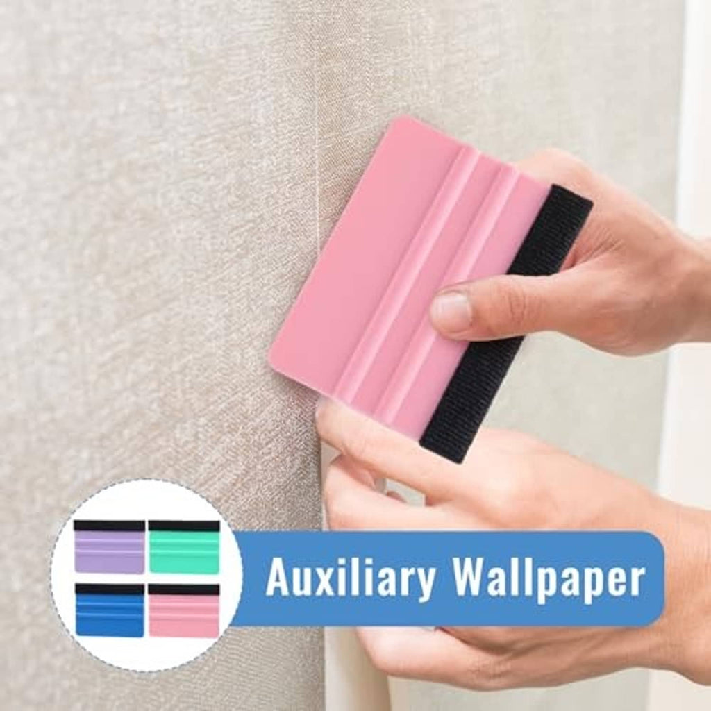 Hands holding a pink felt squeegee for smoothing film on a textured surface