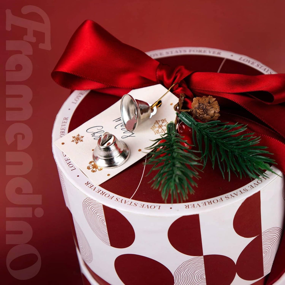 Silver mini jingle bell attached to a red Christmas gift ribbon