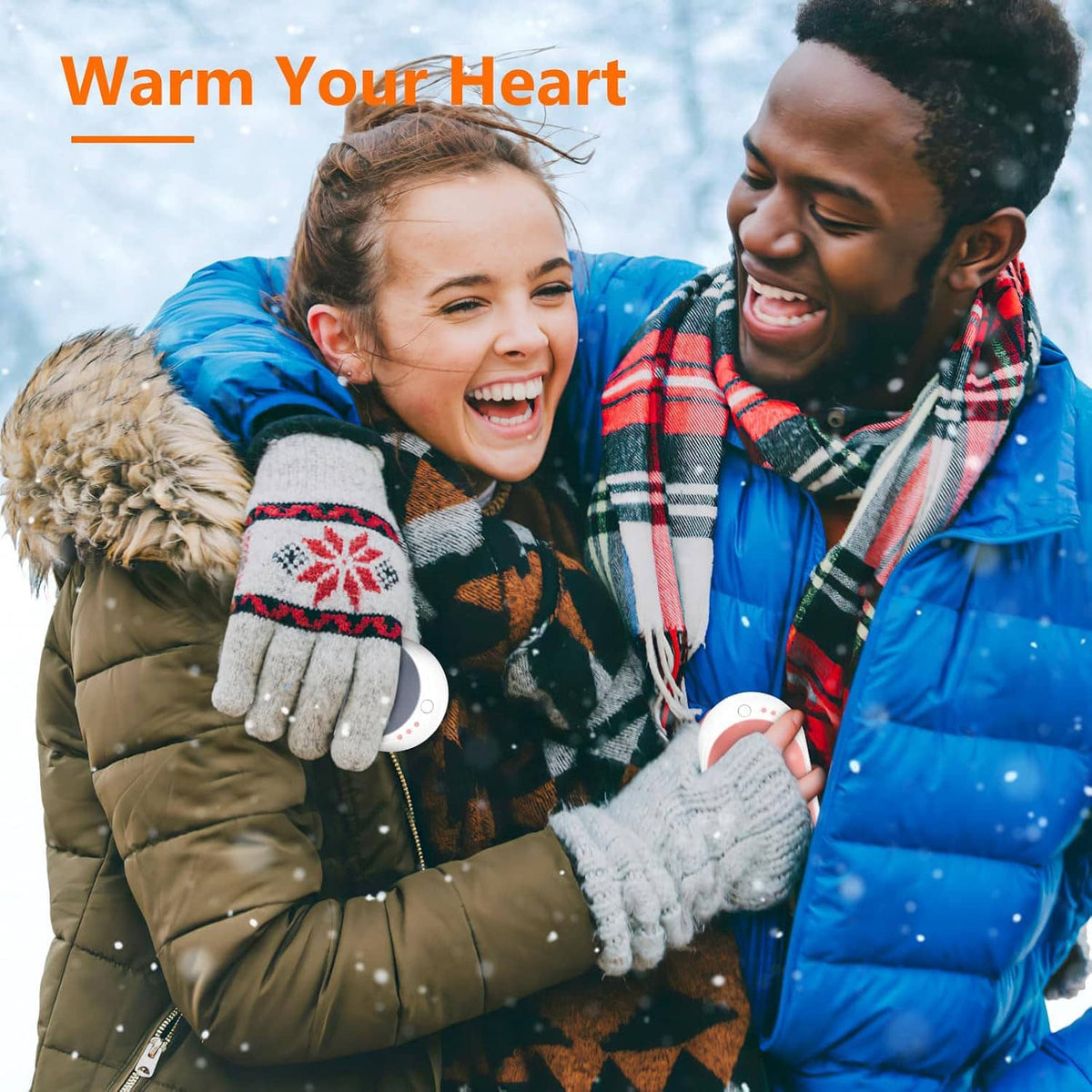 Rechargeable hand warmer held in winter gloves, oval dark gray heater with small indicator light
