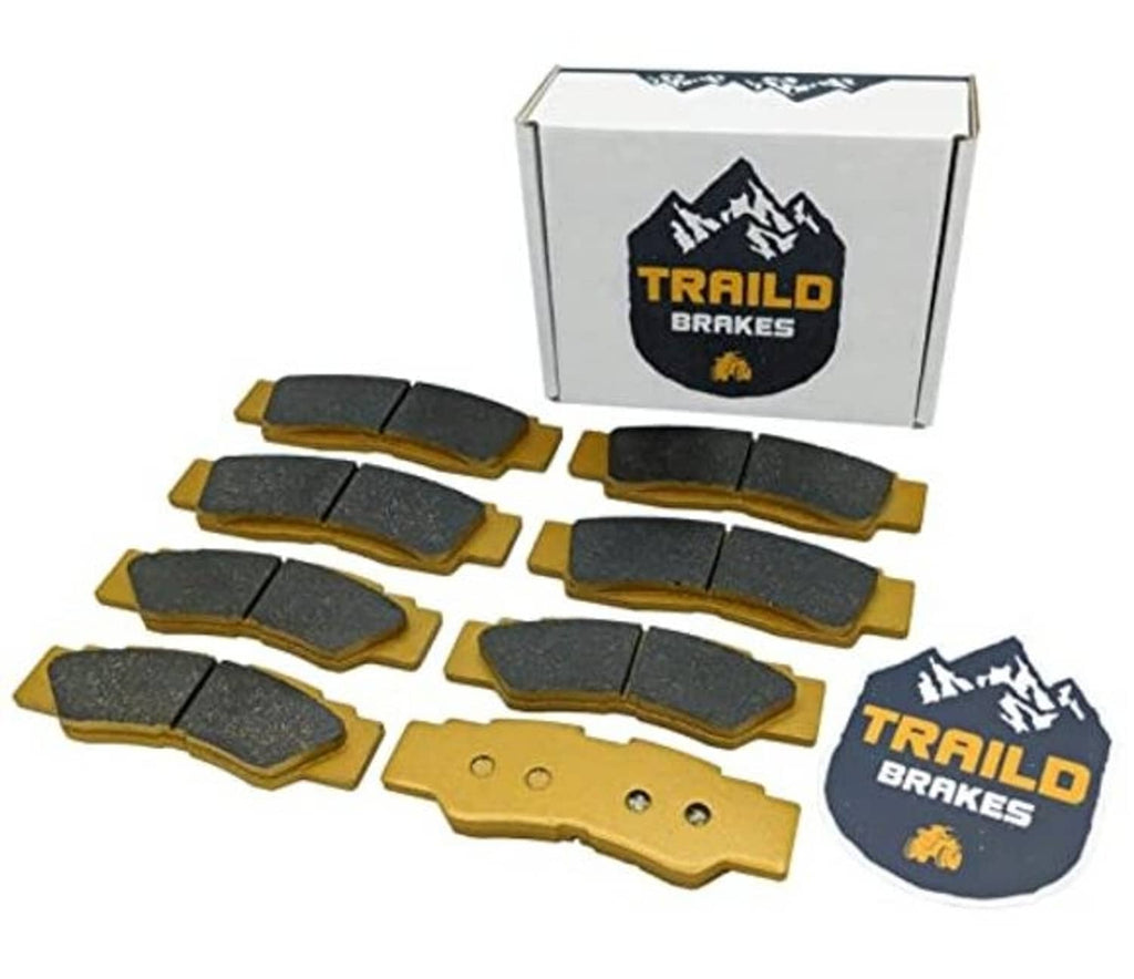 Ceramic brake pad set in retail box with dark pads and gold backing plates