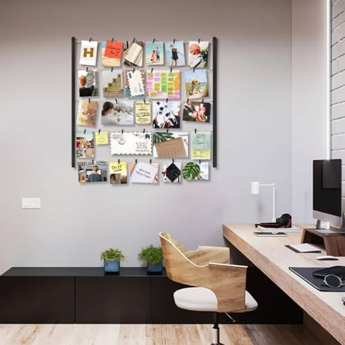 Black solid wood collage picture frame with small clipped photo cards on wall