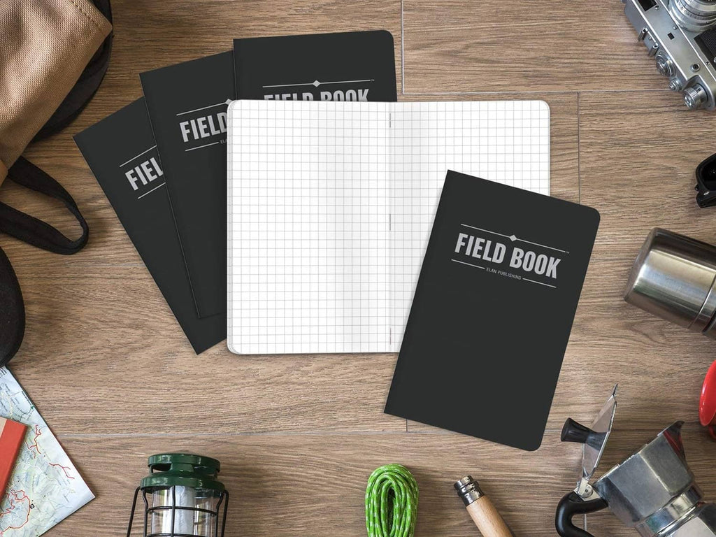 Five black FIELD BOOK pocket notebooks with grid paper, stacked view