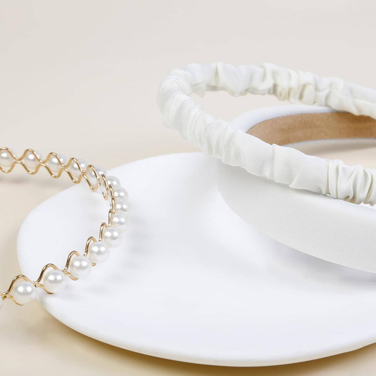 White padded headband with ruched fabric edge and pearl beaded detail