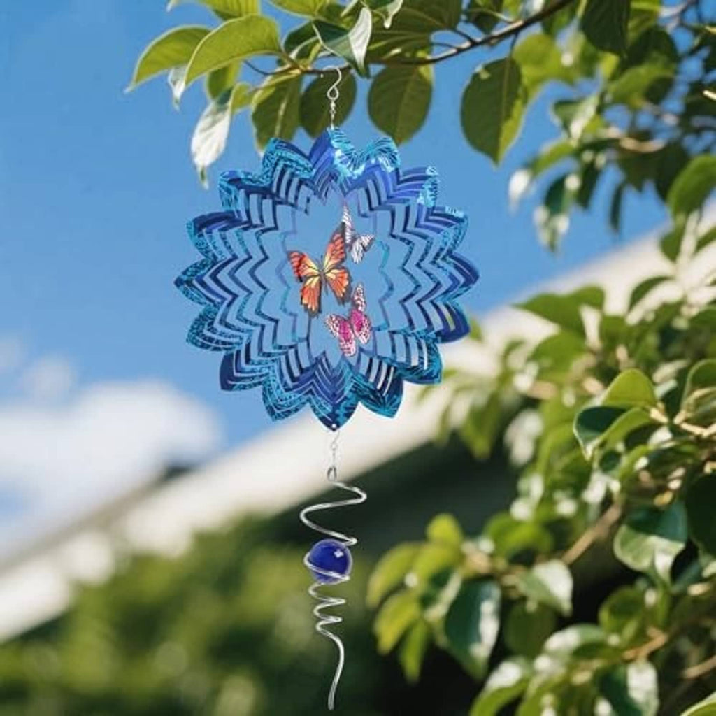 Blue and white butterfly wind spinner hanging outdoors with spiral spring and bead