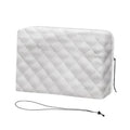Gray quilted indoor air conditioner cover with side cord drawstring for window use.