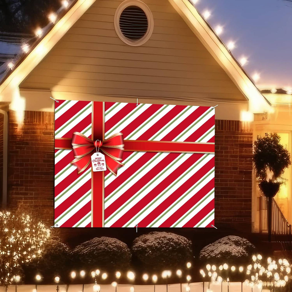 Red and green striped garage door cover with large red bow centerpiece