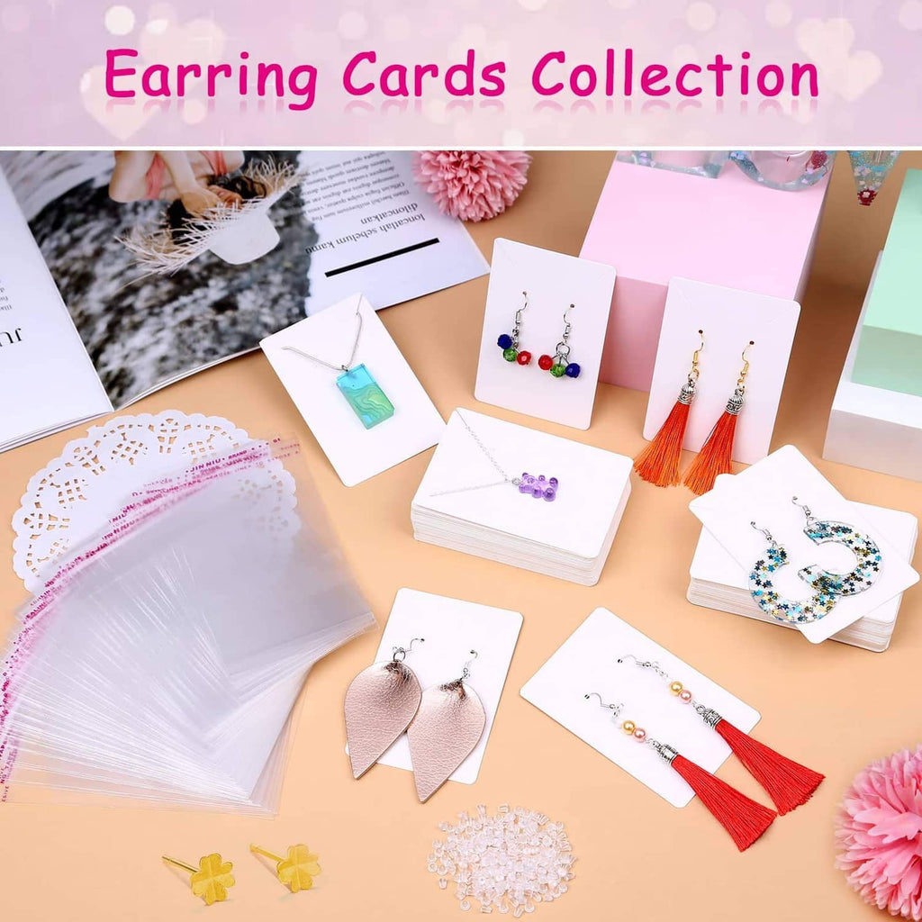 Assorted white earring display cards with various earrings on card inserts