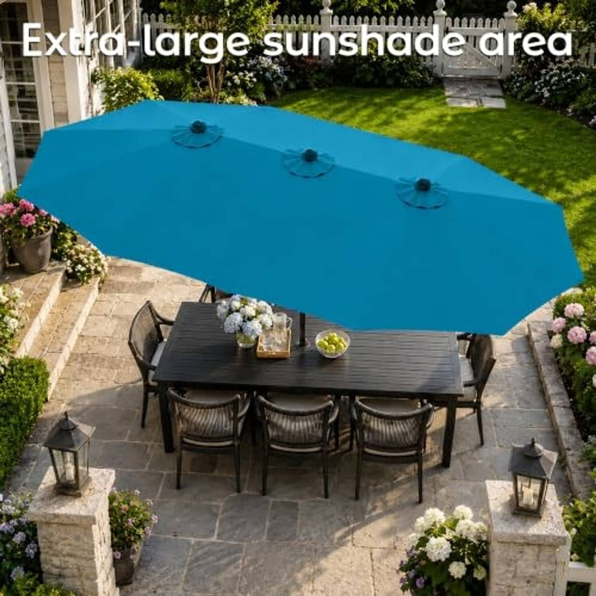 Extra-large teal patio umbrella over outdoor dining table with umbrella base