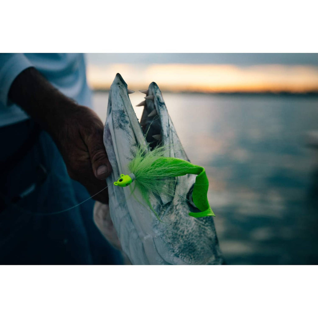 Chartreuse soft bait grub attached to silver fish body lure