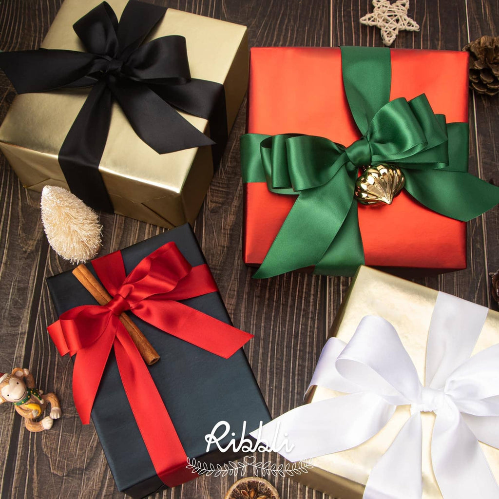 Black satin ribbon bows on gift boxes, shown with different ribbon tail lengths