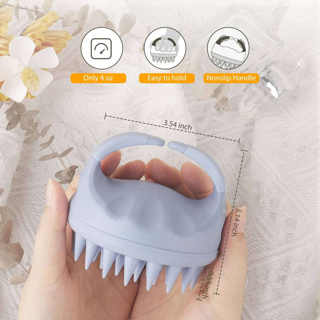 Sky blue scalp massager shampoo brush held in hand, with short silicone bristles